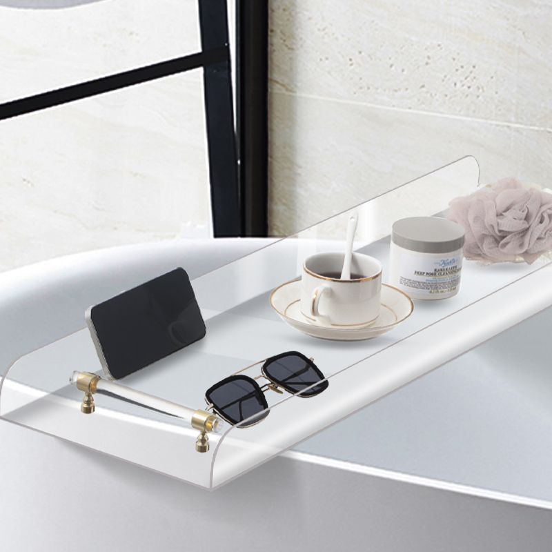 Clear acrylic bath tray with gold-coloured fittings