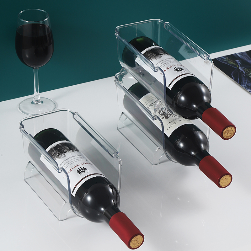 Clear modular wine racks holding three red wine bottles